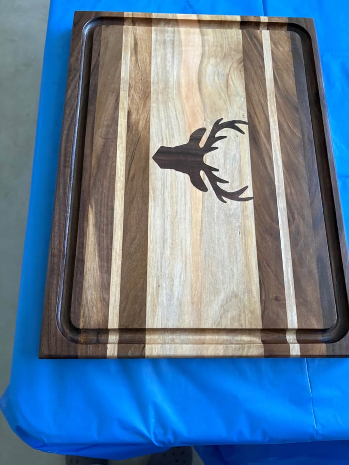 Striped walnut board with deer inlay